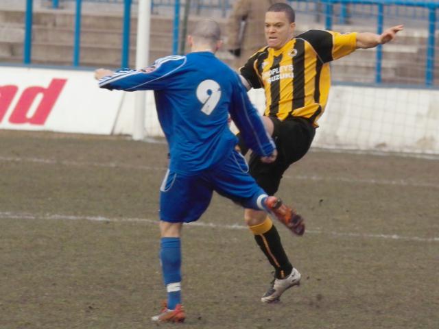 Lee Canoville goes for the ball